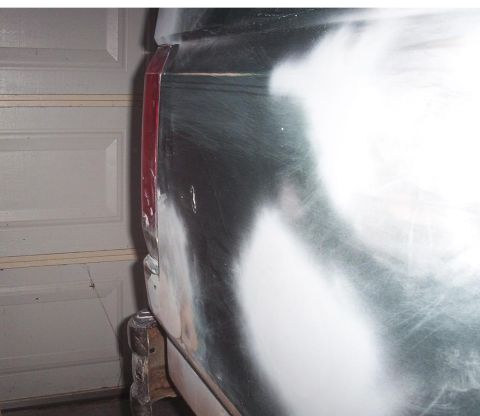 1989 Ford Bronco - This vehicle's rear quarter panel is undergoing body work, with primer and filler visible around the taillight assembly.