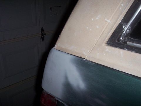 1989 Ford Bronco - This vehicle's rear quarter panel and roofline are being prepped for paint with primer and body filler.