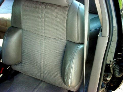 1989 Ford Taurus - Interior view of a car seat, showing fabric and worn leather details.
