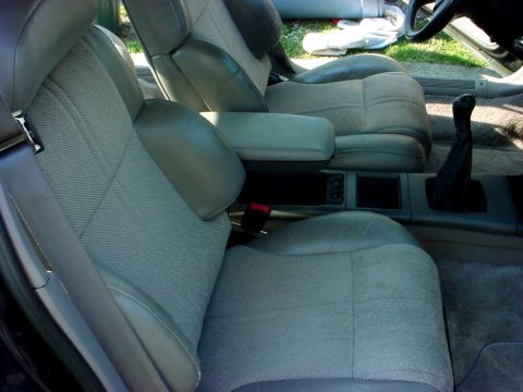 1989 Ford Taurus - Interior view of a car, focusing on the front seats and center console area.