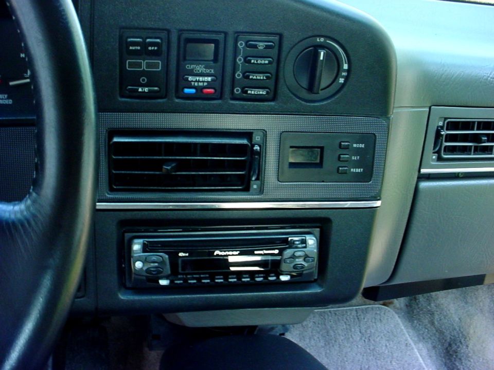 Car dashboard with climate controls, air vents, and a Pioneer stereo