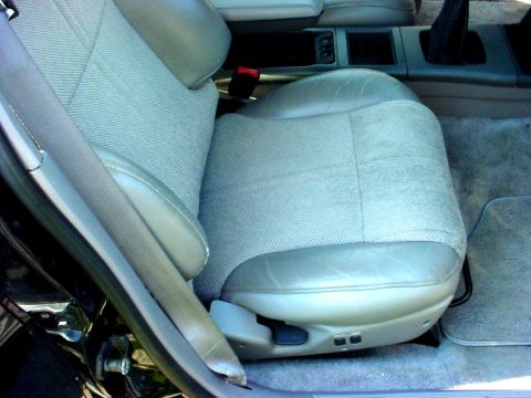 1989 Ford Taurus - Interior view of the driver's seat in a 1989 Ford Taurus, patterned fabric and leather accents.