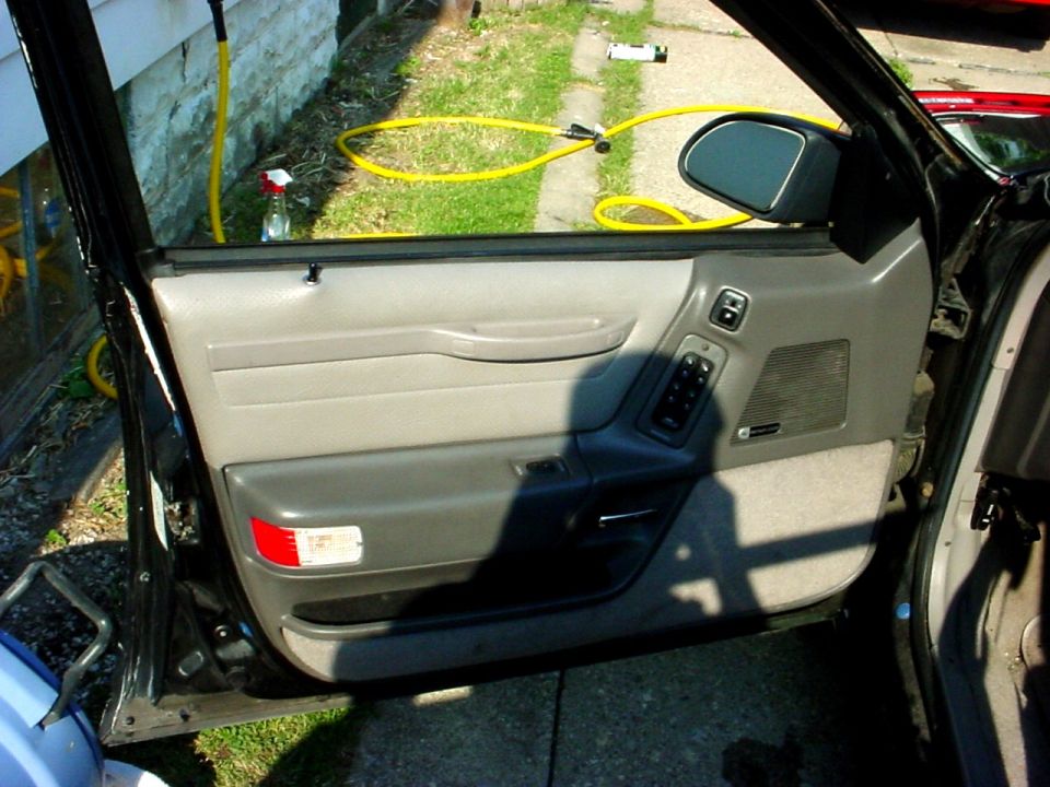 1989 Ford Taurus interior door panel with power window controls and speaker grille