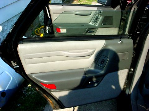1989 Ford Taurus - Interior view of a 1989 Ford Taurus, focusing on the door panels and window controls.