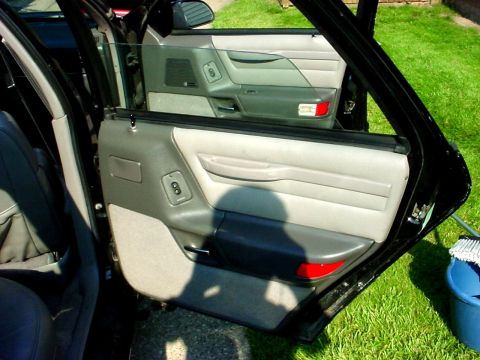 1989 Ford Taurus - Close-up view of the interior door panel, showing the gray fabric and black trim details.