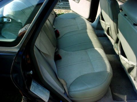 1989 Ford Taurus - Interior view of the rear seats and door panel of a 1989 Ford Taurus.