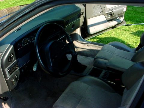 1989 Ford Taurus - The interior of a car is shown with a focus on the dashboard and seating area.