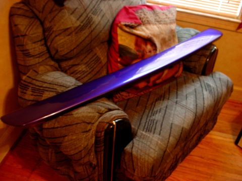 1989 Ford Taurus - A purple car spoiler is placed on a chair, with pillows in the background.