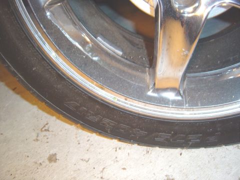 1989 Ford Mustang - Chrome wheel and tire detail, text on sidewall is partially visible.