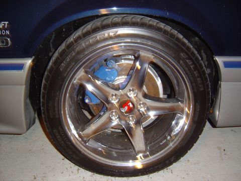 1989 Ford Mustang - Close-up of a chrome wheel with a blue brake caliper and a Falken tire, showing custom modifications.