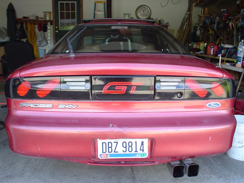 Rear view of red Ford Probe GT in garage with GT badge, Probe 24V lettering, and Ohio plate DBZ 9814