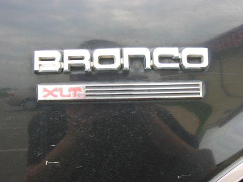 1988 Ford Bronco - The Bronco nameplate and XLT trim level are visible on the vehicle's exterior.