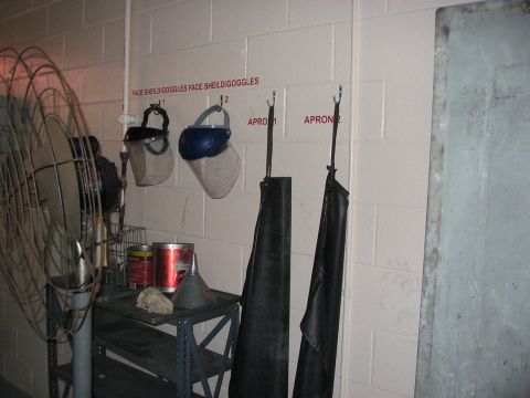 1988 Ford Bronco - Safety gear and supplies are organized on a shelf and wall hooks in what appears to be a workshop or garage.