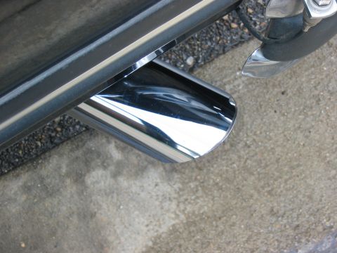 1988 Ford Bronco - Close-up of a shiny chrome exhaust pipe, likely part of a larger vehicle.