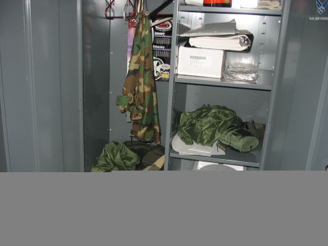 1988 Ford Bronco - Contents of a military locker, including camouflage clothing and storage bags.