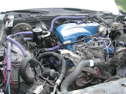1987 Lincoln Town Car - Close-up view of an engine bay with various components and wiring.