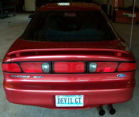 1996 Ford Probe - The rear of a red Ford Probe shows 'PROBE 24V' badging and a custom Virginia license plate.