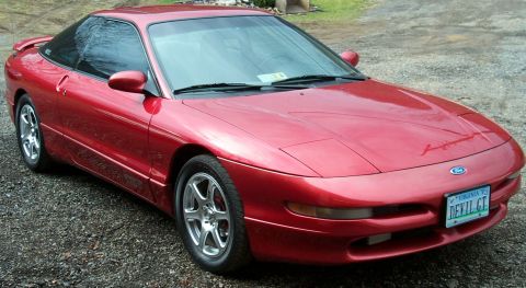 1996 Ford Probe - A red 1996 Ford Probe is parked on a gravel driveway.
