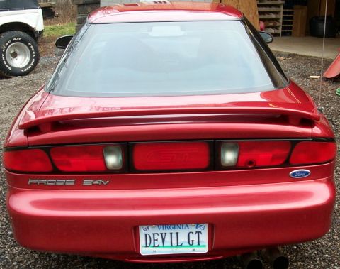 1996 Ford Probe - Rear view of a red 1996 Ford Probe GT, showing its taillights, spoiler, and Virginia license plate.