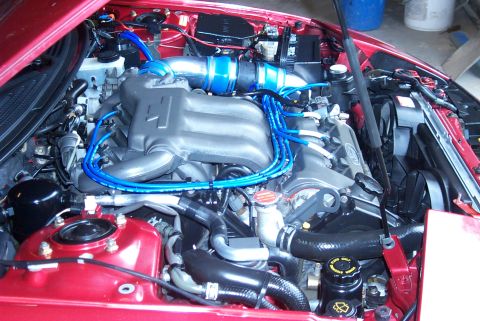 1996 Ford Probe - Close-up view of a car's engine bay, highlighting the intake manifold and spark plug wires.