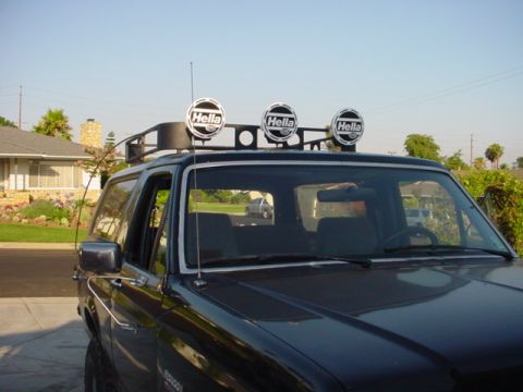 1988 Ford Bronco - A 1988 Ford Bronco is shown with a roof rack equipped with three Hella lights and an antenna.