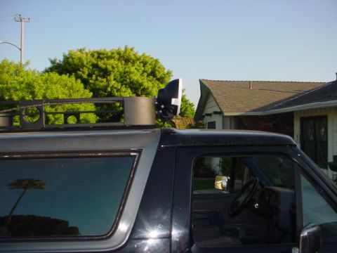 1988 Ford Bronco - This Ford Bronco, likely a 1987 model, is seen from the side with a roof rack and auxiliary light attached.