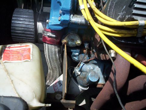 1978 Ford Mustang II - Close-up view of engine components, including a coolant reservoir and spark plug wires.