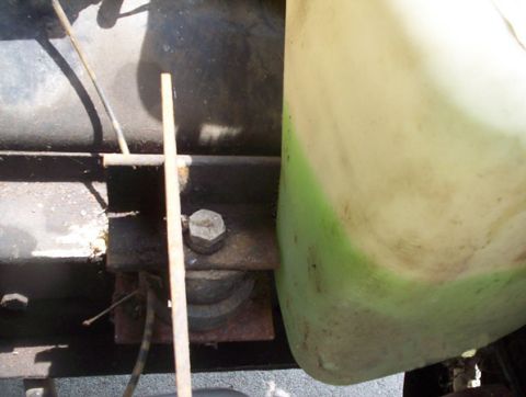 1978 Ford Mustang II - A close-up view of a fluid reservoir, possibly from an engine bay, with visible green markings.