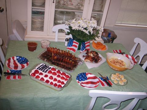 1995 Ford Bronco - A table is set for a celebration with American flag-themed decorations and a variety of food dishes.