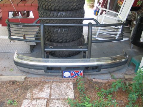 1995 Ford Bronco - Front bumper and brush guard assembly for a 1995 Ford Bronco, a chrome finish and a decorative license plate.