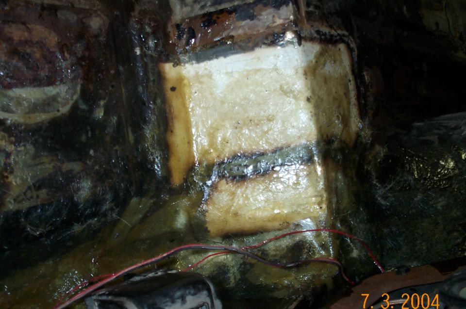 Drivers side after patches welded in and covered with fiberglass and resin.