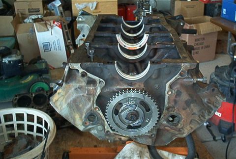 1986 Ford Bronco - Engine block with crankshaft gear and main bearings visible, likely during a rebuild.