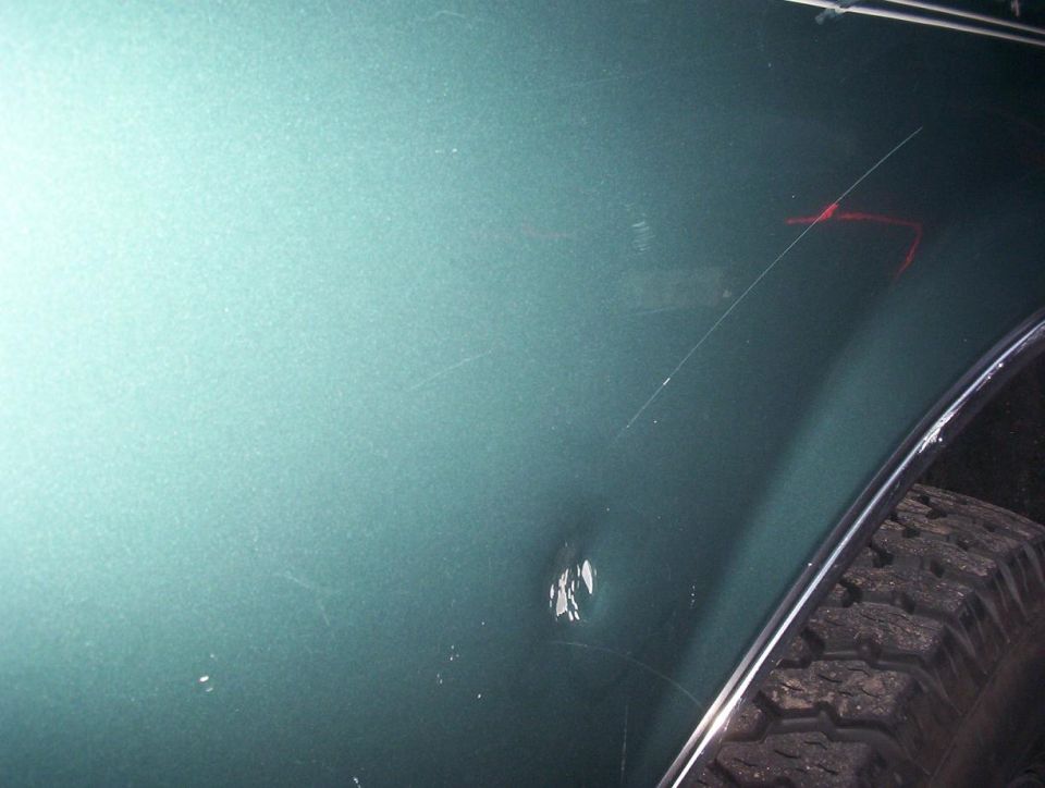 dent behind wheel well