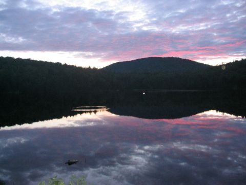 1986 Ford Bronco - A lake reflects the colorful sky during dusk, with silhouetted hills in the background.