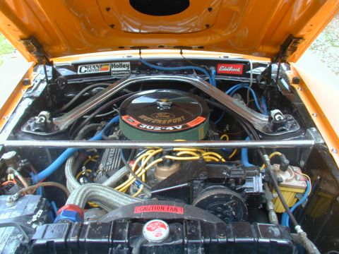 1988 Ford Bronco - Engine bay view of a Ford 302-4V motor, aftermarket performance parts.
