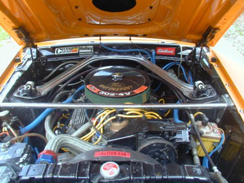 1988 Ford Bronco - The engine bay of a car, a Ford Motorsport air cleaner and various aftermarket performance parts.