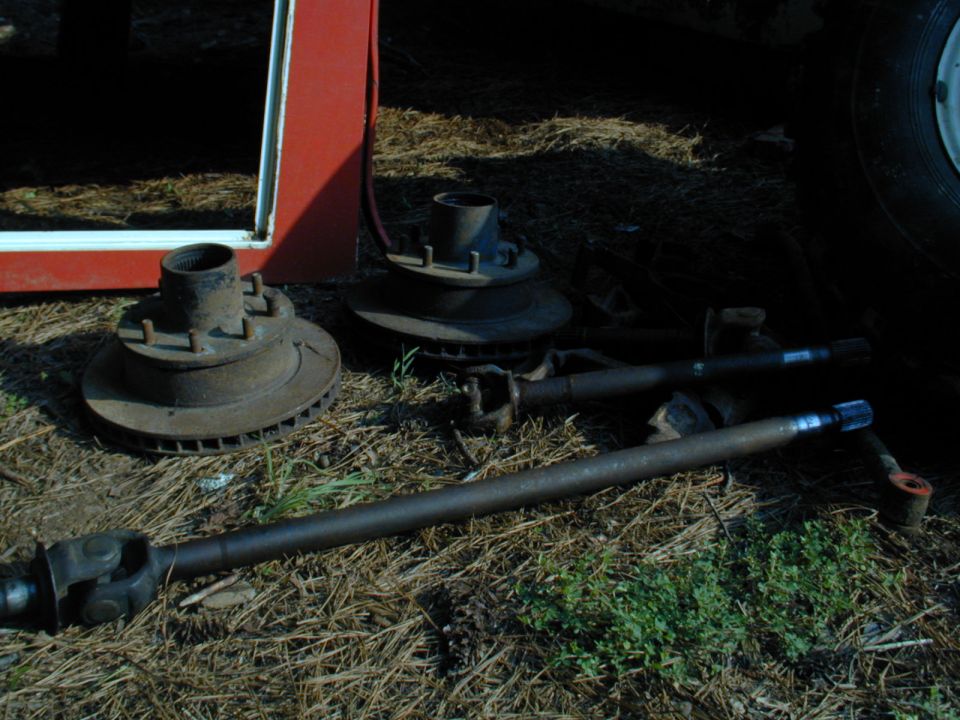 Vehicle axle shafts and brake rotors with hubs on the ground