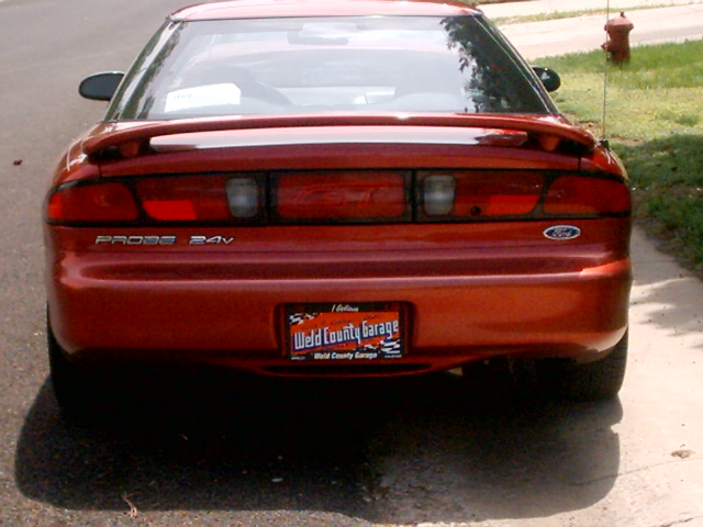 Red 1996 Ford Probe rear with 'PROBE 24V' badge and Weld County Garage license plate