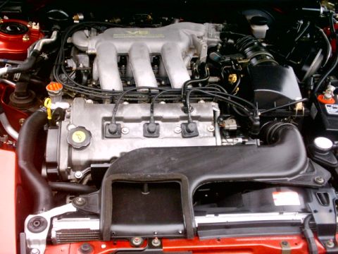 1996 Ford Probe - Close-up view of a vehicle's engine bay, showing the intake manifold and spark plug wires.