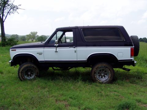 1983 Ford Bronco - This two-tone 1983 Ford Bronco is seen from the side, a spare tire mounted on the rear door.