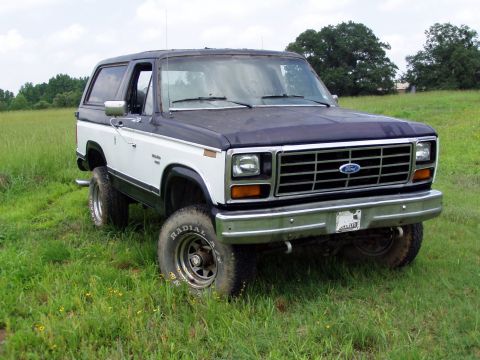 1983 Ford Bronco - This Ford Bronco is shown from the front-right in a grassy field.