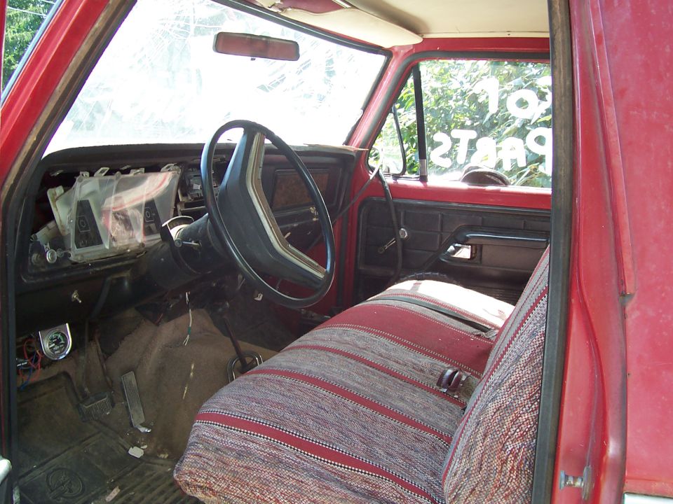 1979 Ford F-150 interior showing dashboard, steering wheel, and patterned seat