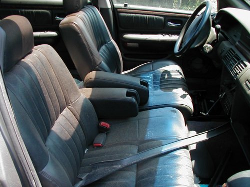 Interior view of a car with cloth and leather seats, dashboard, and steering wheel