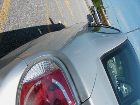 1997 Ford Taurus - A silver sedan is parked in a lot next to another vehicle, with yellow lines on the asphalt.