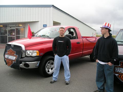 1996 Ford Bronco - Two men stand next to a red pickup truck decorated with patriotic streamers.