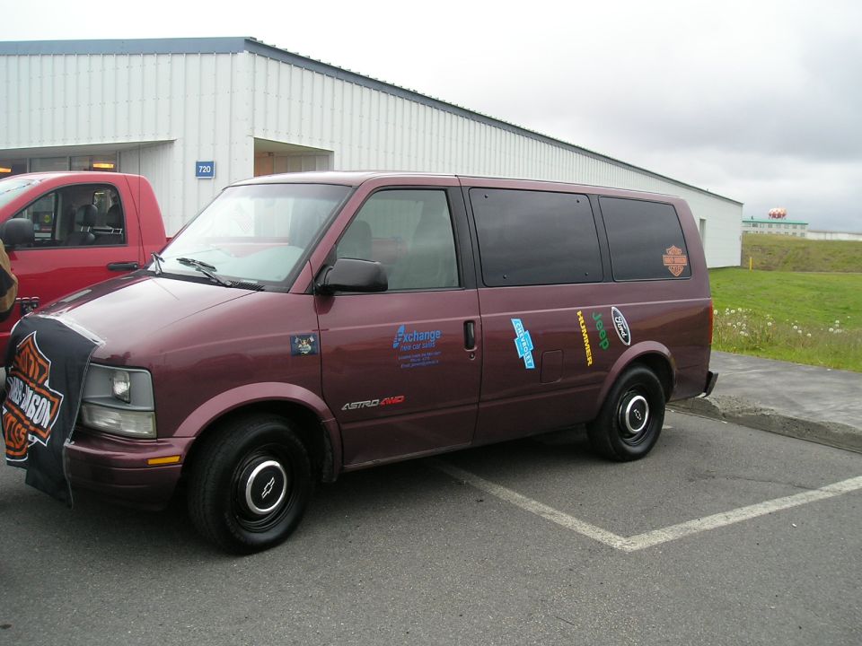 Maroon Chevrolet Astro AWD van, 3/4 front view, with decals and Harley cloth on grille