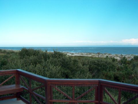 1998 Ford Taurus - A view of the ocean and beach from a wooden deck.