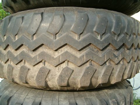 1991 Ford Bronco - Close-up view of stacked tires, showing their tread pattern and some visible text at the bottom.