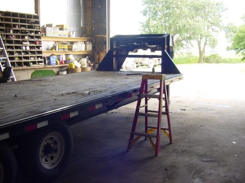 1992 Ford Bronco - Gooseneck trailer hitch assembly on a flatbed trailer in a workshop setting.