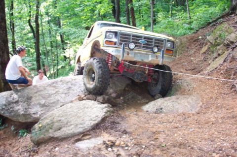 1985 Ford Bronco - Front view of high centered on rock.